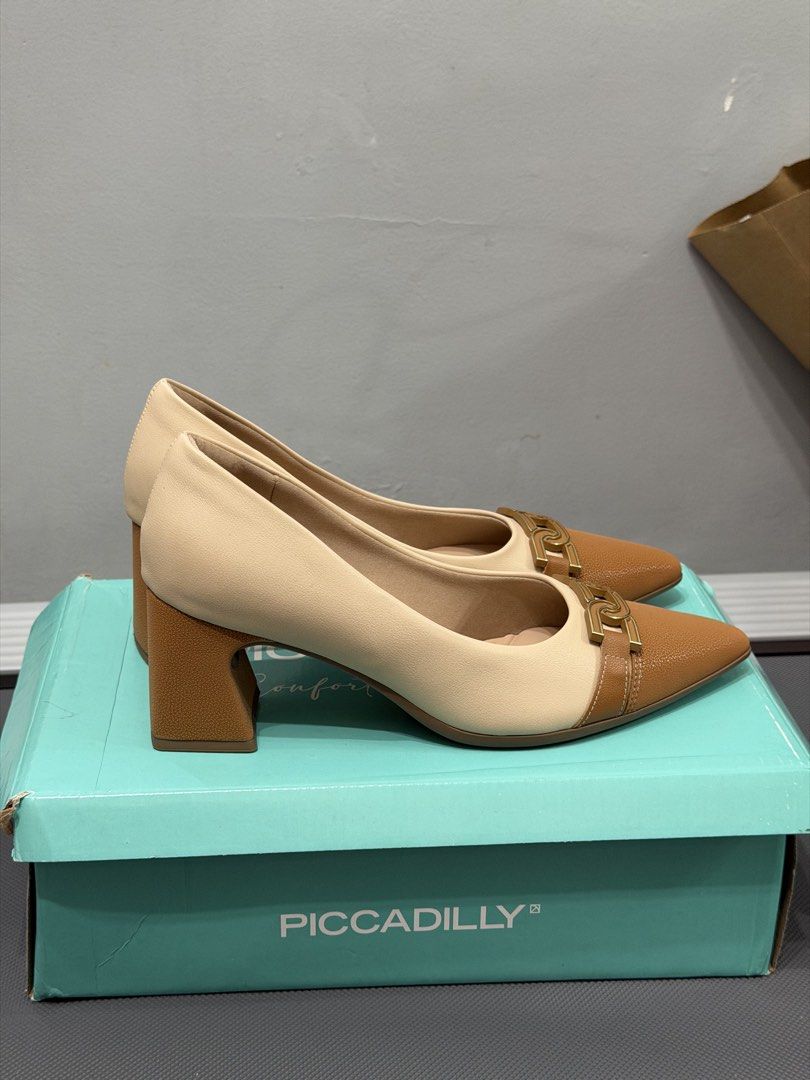 Piccadilly Two-Tone Block Heel Pumps (Category: Heels) located in Makati City. Submitted by rrlimbo (Listing ID 1467255776, Image 2). Description: - Brand: Piccadilly - Size: 7 - Color: Beige and brown - Comfort: Soft cushioned insoles for all-day wear - Inclusion: Original box - Condition: Excellent, wear 2x only RFS: Wrong size Original Price: 3,011.00 📍Makati.