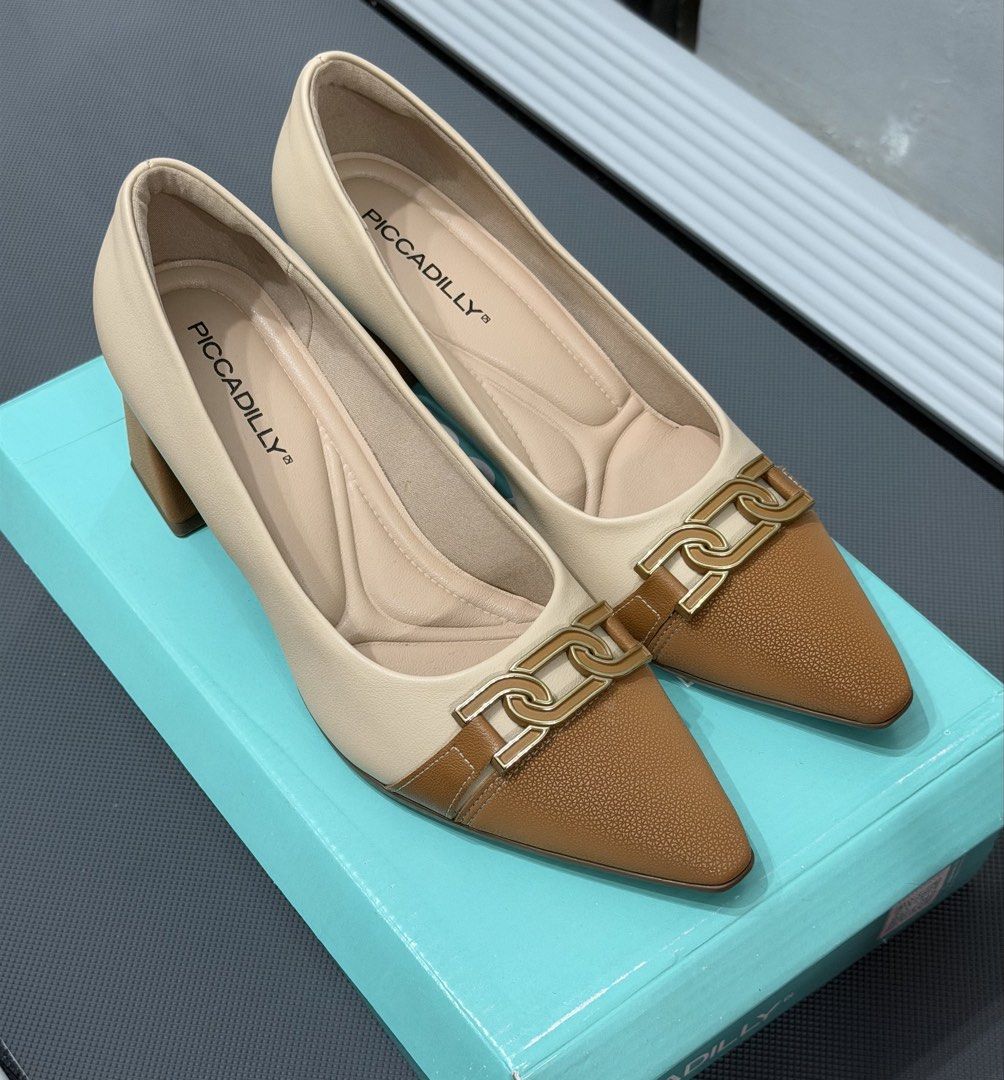 Piccadilly Two-Tone Block Heel Pumps (Category: Heels) located in Makati City. Submitted by rrlimbo (Listing ID 1467255776, Image 1). Description: - Brand: Piccadilly - Size: 7 - Color: Beige and brown - Comfort: Soft cushioned insoles for all-day wear - Inclusion: Original box - Condition: Excellent, wear 2x only RFS: Wrong size Original Price: 3,011.00 📍Makati.