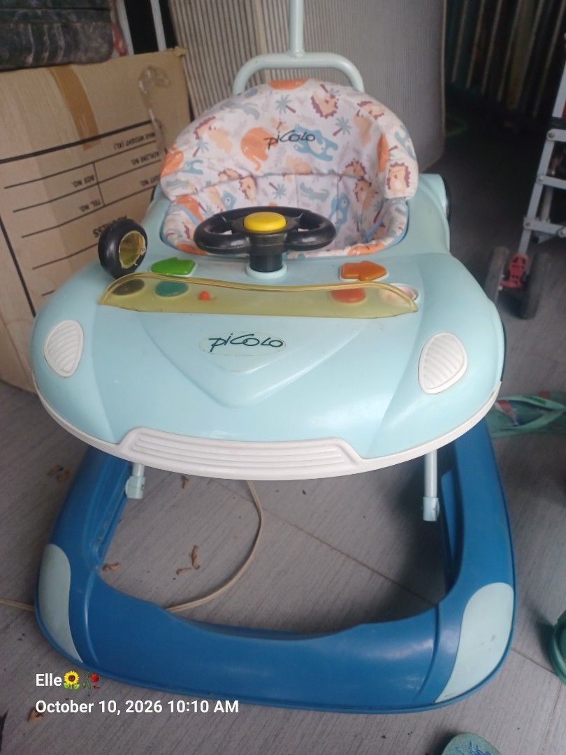 Picolo Baby Walker with Steering Wheel (Category: Infant Playtime) located in Manila. Submitted by claudiee957 (Listing ID 1467200826, Image 2). Description: - Brand/Model: Picolo Baby Walker - Color: Light blue with blue accents - Seat: Comfortable animal print fabric seat - Entertainment: Built-in steering wheel toy and interactive buttons on the activity tray - Convenience: Includes a push handle at the back for parents - Build: Sturdy and dur