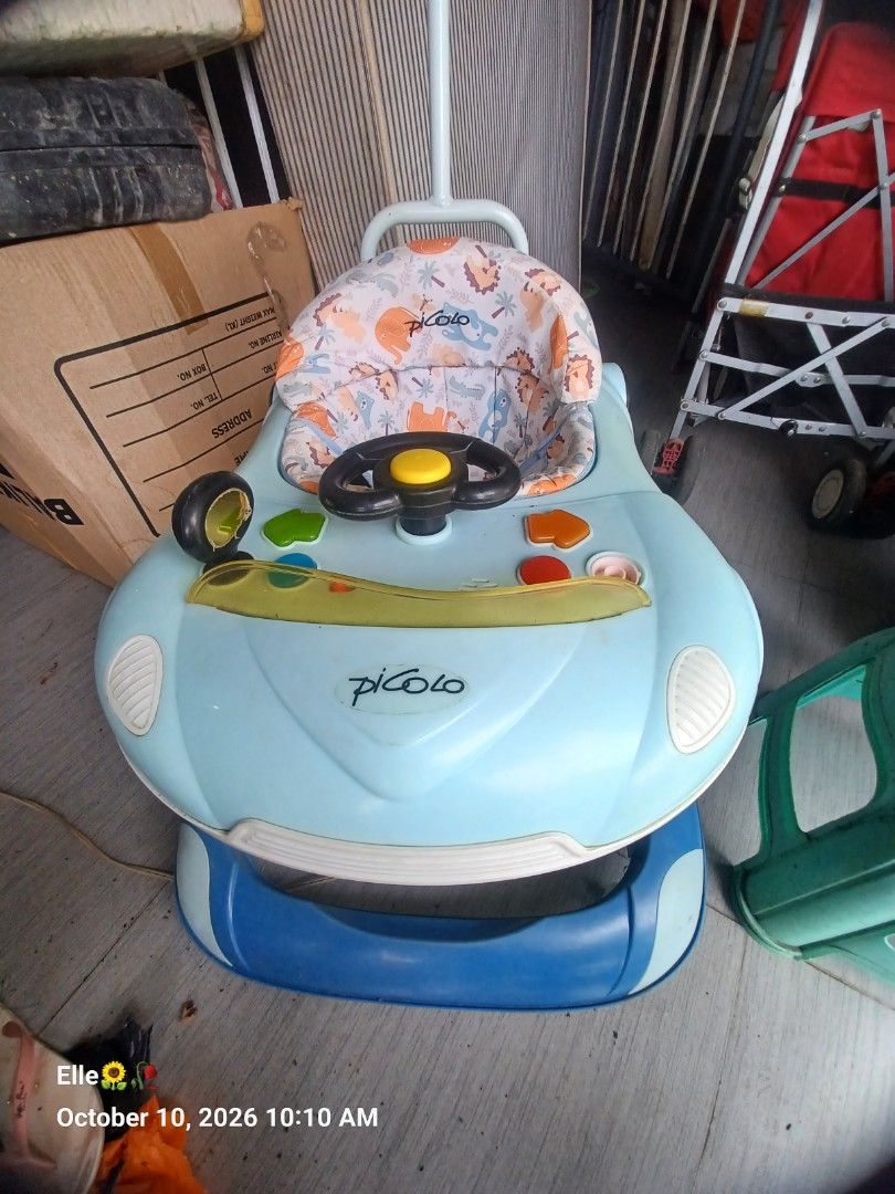 Picolo Baby Walker with Steering Wheel (Category: Infant Playtime) located in Manila. Submitted by claudiee957 (Listing ID 1467200826, Image 1). Description: - Brand/Model: Picolo Baby Walker - Color: Light blue with blue accents - Seat: Comfortable animal print fabric seat - Entertainment: Built-in steering wheel toy and interactive buttons on the activity tray - Convenience: Includes a push handle at the back for parents - Build: Sturdy and dur