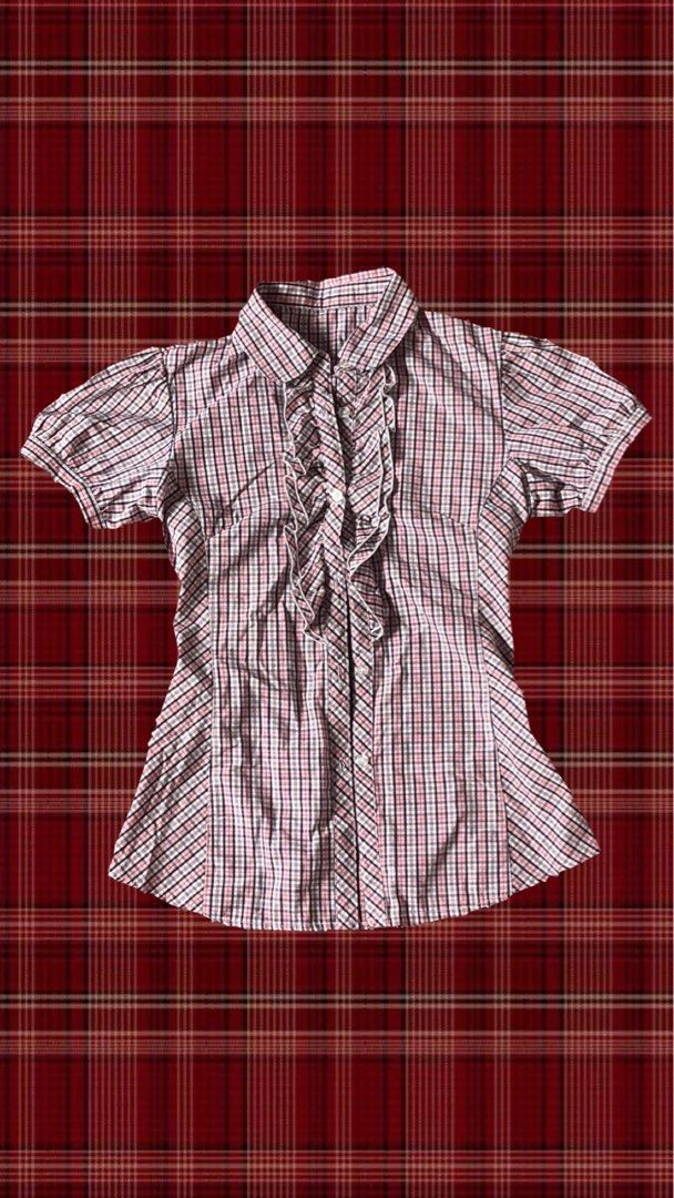 Pink Plaid Ruffle Button-Up Short Sleeve Blouse (Category: Blouses) located in Quezon City. Submitted by gloriouslilith (Listing ID 1467175654, Image 1). Description: - Color: Pink, black, and white plaid pattern -fits to S-M - Sleeves: Short puff sleeves with button cuffs - Closure: Front button-up with stylish white-trimmed ruffles - Fit: Tailored front and back paneling for a fitted silhouette - Neckline: Classic collared neckline -good for so
