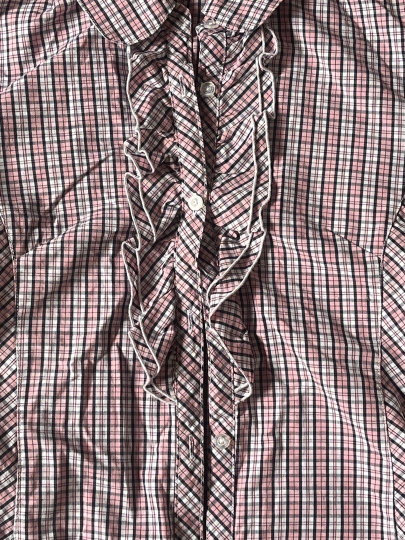 Pink Plaid Ruffle Button-Up Short Sleeve Blouse (Category: Blouses) located in Quezon City. Submitted by gloriouslilith (Listing ID 1467175654, Image 3). Description: - Color: Pink, black, and white plaid pattern -fits to S-M - Sleeves: Short puff sleeves with button cuffs - Closure: Front button-up with stylish white-trimmed ruffles - Fit: Tailored front and back paneling for a fitted silhouette - Neckline: Classic collared neckline -good for so