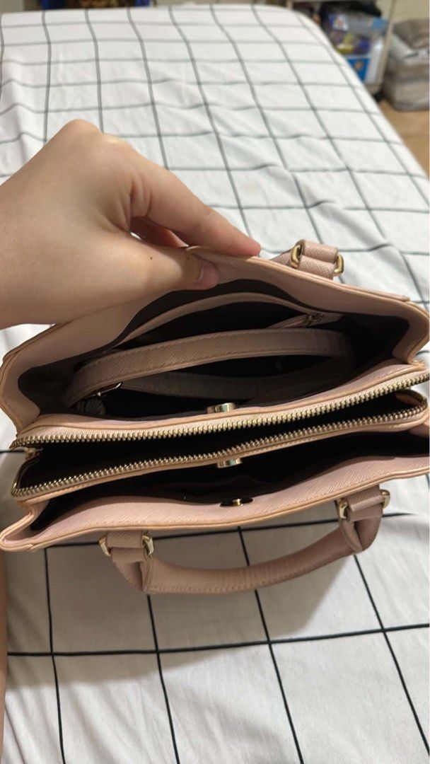 Pink Tote Bag with Multiple Compartments (Category: Tote Bags) located in Manila. Submitted by ysabellade60459 (Listing ID 1467339145, Image 2). Description: - Color: Light pink with elegant gold-tone hardware - Versatile carry: Includes double top handles and a detachable shoulder strap - Organized interior: 3 main compartments including a secure center zip section - Extras: Clean lining with convenient inner slip pockets - Mode of Payment: GCas