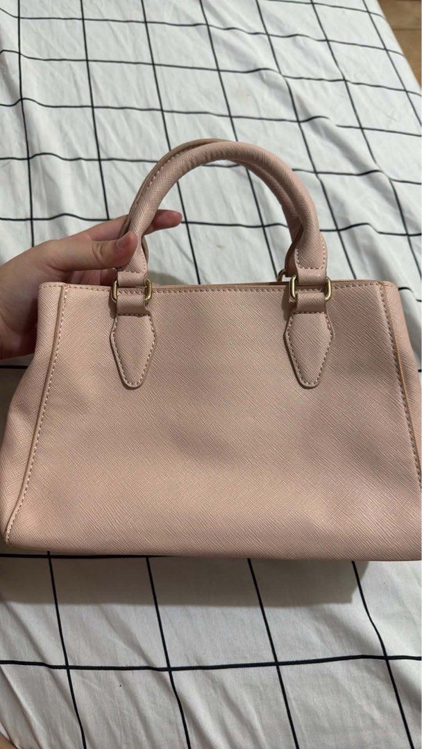 Pink Tote Bag with Multiple Compartments (Category: Tote Bags) located in Manila. Submitted by ysabellade60459 (Listing ID 1467339145, Image 1). Description: - Color: Light pink with elegant gold-tone hardware - Versatile carry: Includes double top handles and a detachable shoulder strap - Organized interior: 3 main compartments including a secure center zip section - Extras: Clean lining with convenient inner slip pockets - Mode of Payment: GCas
