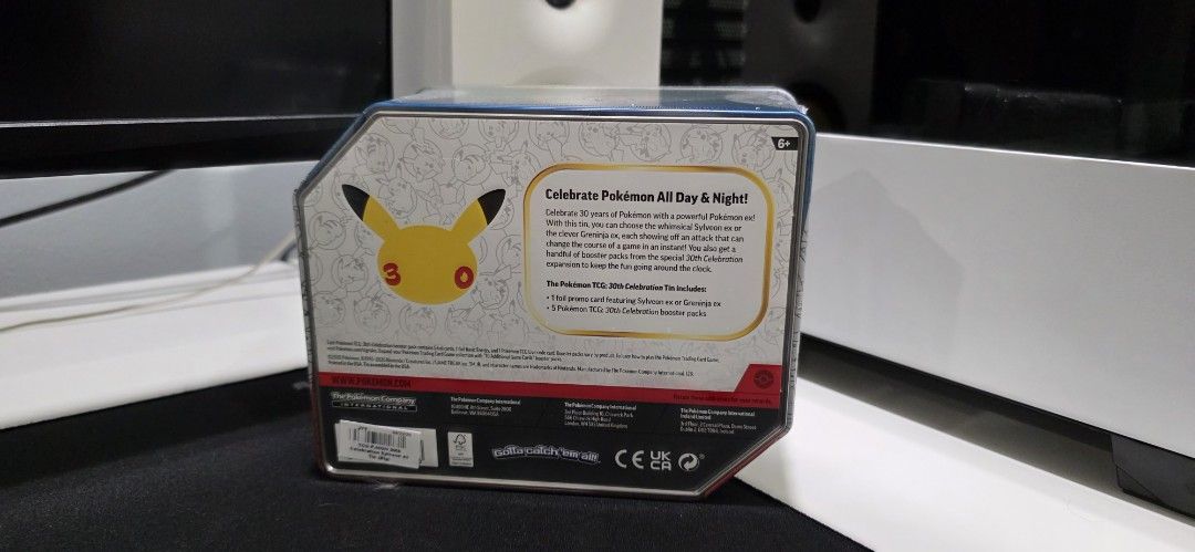 Pokémon 30th Celebration Tin English (Category: Card Boxes & Cases) located in San Juan City. Submitted by SoleTech_Manila (Listing ID 1467297944, Image 2). Description: - Factory-sealed Pokémon 30th Celebration tin featuring Sylveon ex - Pristine, unopened condition with original plastic wrap intact - Includes 1 exclusive foil promo card of Sylveon ex - Comes with 5 Pokémon TCG 30th Celebration booster packs - Perfect addition for TCG collectors