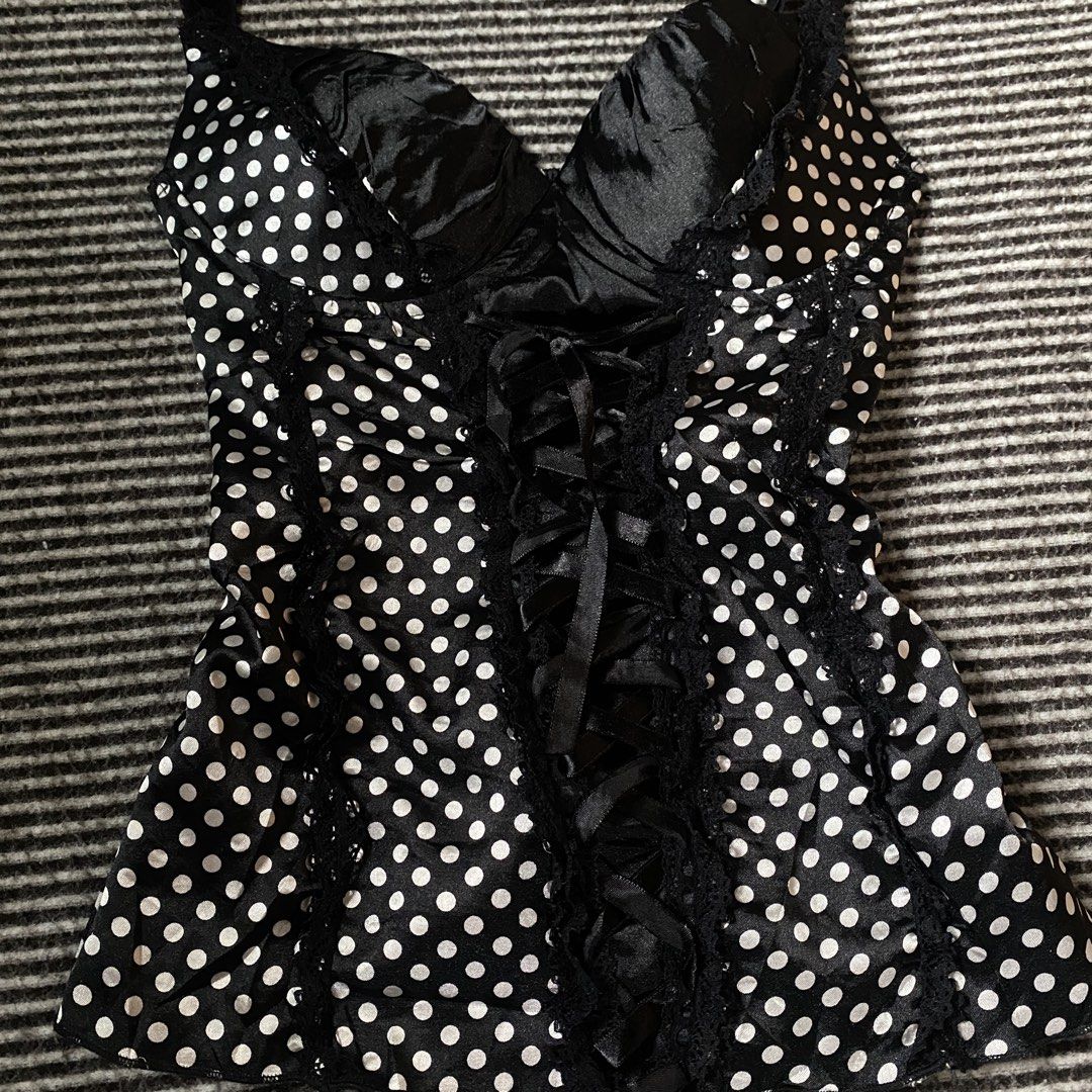 Polka Corset Top Lace Up (Category: Sleeveless) located in Manila. Submitted by isellgoodshi (Listing ID 1466817858, Image 2). Description: - Style: Black corset top with white polka dots - Support: Satin cups with underwire - Details: Ribbon lace-up front with black lace trim - Fit: Stretchy smocked back panel for comfort - Straps: Adjustable thin straps.