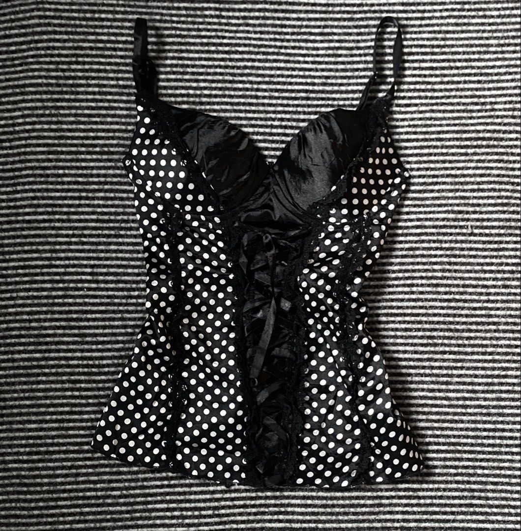 Polka Corset Top Lace Up (Category: Sleeveless) located in Manila. Submitted by isellgoodshi (Listing ID 1466817858, Image 1). Description: - Style: Black corset top with white polka dots - Support: Satin cups with underwire - Details: Ribbon lace-up front with black lace trim - Fit: Stretchy smocked back panel for comfort - Straps: Adjustable thin straps.