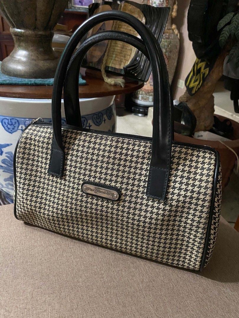 Polo Ralph Lauren Houndstooth Barrel Handbag Imitation (Category: Luxury Bags & Wallets) located in Paranaque City. Submitted by zackzero (Listing ID 1467228471, Image 3). Description: - Polo Ralph Lauren barrel bag IMITATION - Chic black and white houndstooth pattern with black leather handles and trim - Sleek silver-tone metal hardware and front brand plaque - Convenient exterior zip pocket on the back - Smooth-zippered main compartment with a 