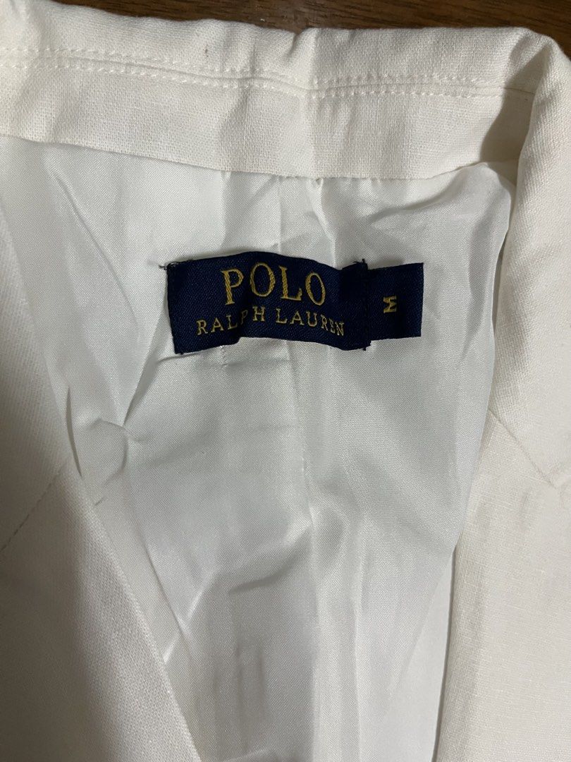 Polo Ralph Lauren White Blazer Size M (Category: Coats, Jackets and Outerwear) located in Mandaluyong City. Submitted by dadsmiddlechild (Listing ID 1467353525, Image 2). Description: - Brand: Polo Ralph Lauren - Color: Crisp White - Size: Medium (Tag attached at collar) - Closure: Single tortoiseshell-style button - Pockets: Two front jetted pockets - Details: Structured lapels and fully lined interior - Condition: Brand new with tags, clean fin