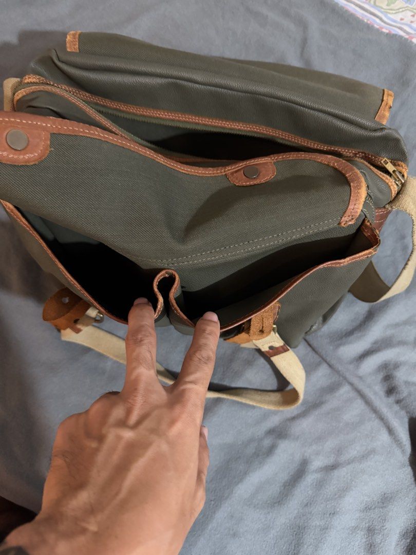 Porter laptop and messenger bag (Category: Sling Bags) located in Manila. Submitted by daleyo (Listing ID 1467292420, Image 3). Description: Pre loved item bought in Japan in 2019 Color - army green no scratches, no stitches Solid na leather ito. Can bring more items books, laptop, toiletrees etc. .