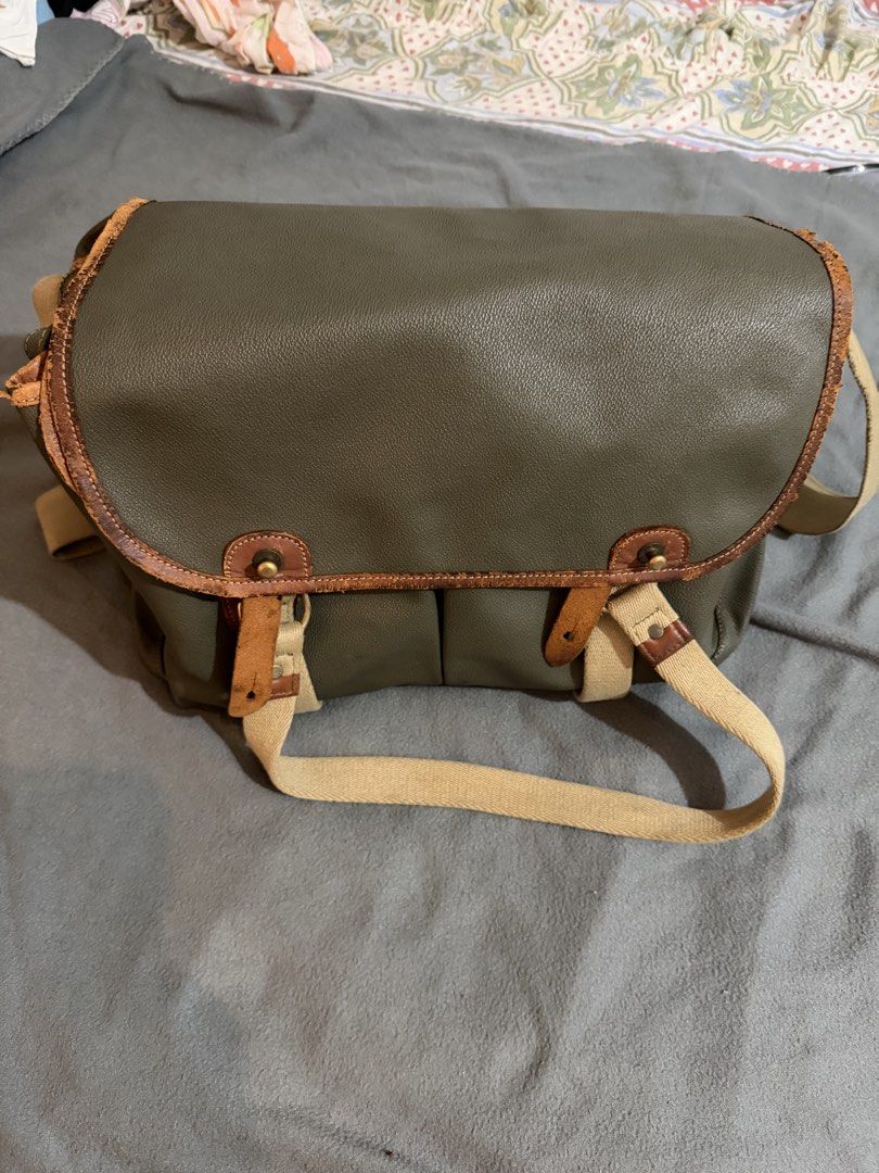 Porter laptop and messenger bag (Category: Sling Bags) located in Manila. Submitted by daleyo (Listing ID 1467292420, Image 1). Description: Pre loved item bought in Japan in 2019 Color - army green no scratches, no stitches Solid na leather ito. Can bring more items books, laptop, toiletrees etc. .