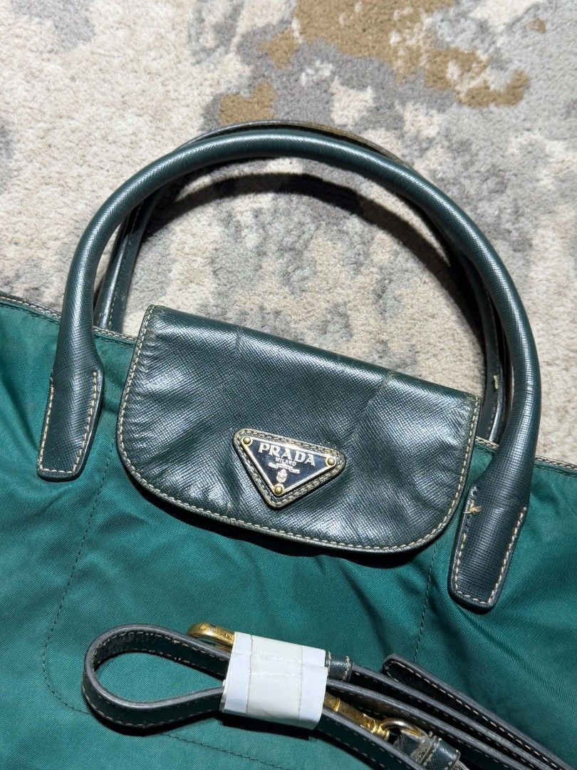 Prada Green Nylon with sling Tote Bag (Category: Luxury Bags & Wallets) located in Dagupan City. Submitted by kiroshi12 (Listing ID 1467238437, Image 3). Description: - Authentic Green Prada Tote Bag - Durable nylon material with chic leather handles - Front flap pocket featuring the iconic Prada triangle logo plaque - Premium gold-tone hardware and secure top zip closure with riri zipper - Includes a matching detachable shoulder strap (still wra