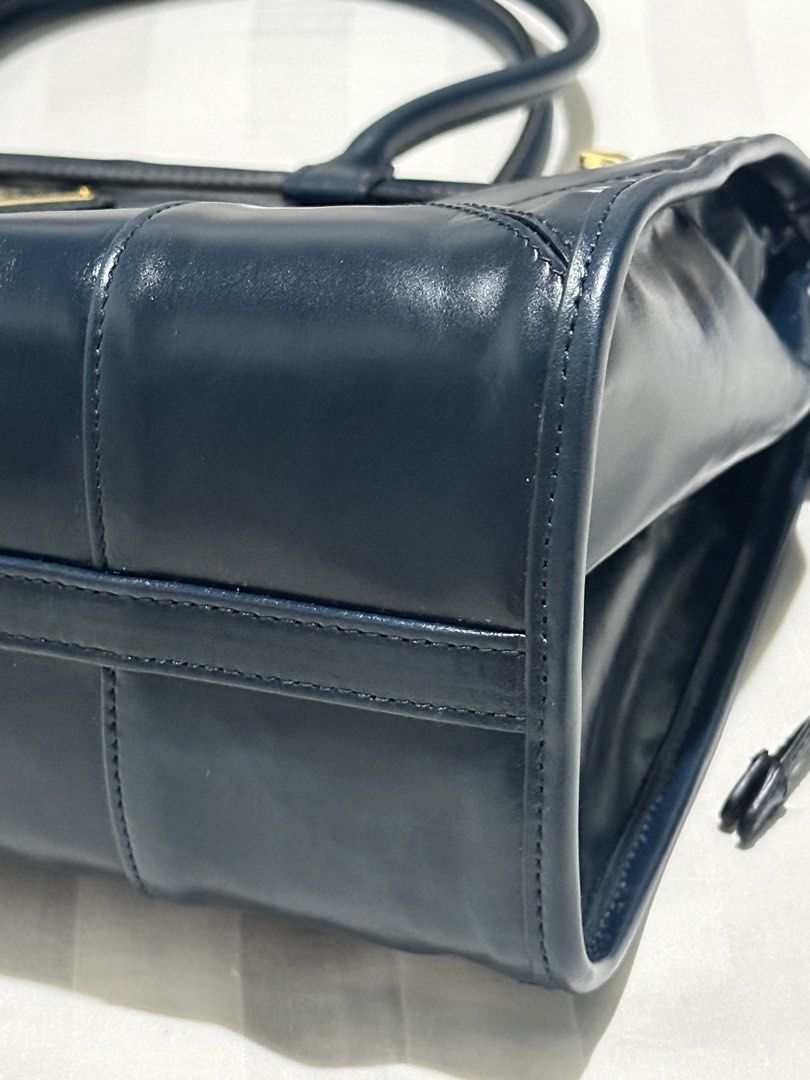 Prada Navy Leather Tote Handbag (Category: Luxury Bags & Wallets) located in Manila. Submitted by willtradeforbags (Listing ID 1467362756, Image 3). Description: Curated buy from Japan. Genuine leather and doesn’t easily get scratched. Used it a couple of times. Comes with dust bag. Didn’t have it authenticated hence the price. But the leather is genuine and is comparable to the one I bought from the store. .