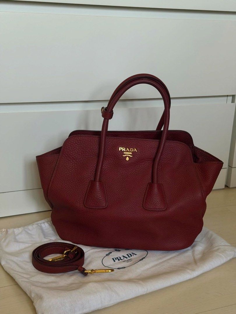 Prada Red Leather Tote Bag with Strap (Category: Luxury Bags & Wallets) located in Las Pinas. Submitted by reijeancaraig (Listing ID 1467325803, Image 1). Description: - Authentic Prada tote bag in a stunning deep red pebbled leather - Elegant gold hardware details and iconic front logo lettering - Versatile design with double top handles and a detachable shoulder strap - Spacious interior with a soft, comfortable structure - Comes complete with 