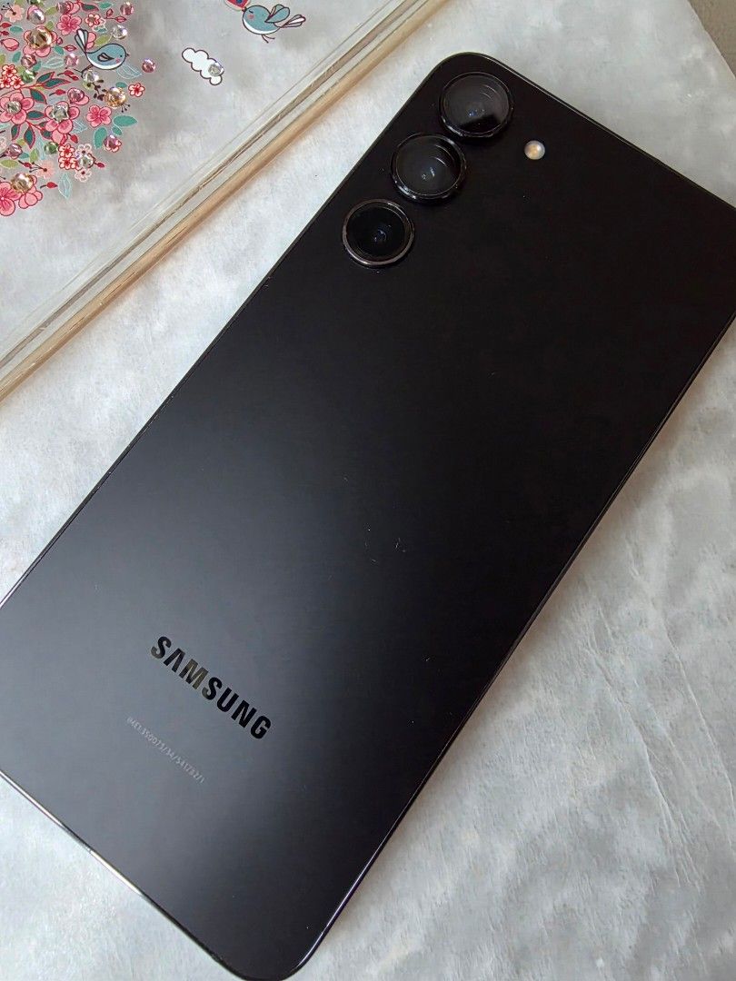 Preloved Samsung Galaxy S23+ (Category: Samsung) located in Taguig. Submitted by rochev (Listing ID 1467267389, Image 2). Description: - Model: Preloved Samsung Galaxy S23+ (256GB storage) - Color: Elegant Black - Condition: Good overall body condition, note minor crack on the right side of the display (fully tested and working) - Unit only and open line - Freebies: Includes 2 protective cases (floral design & rugged bumper case) - Meetup Locatio