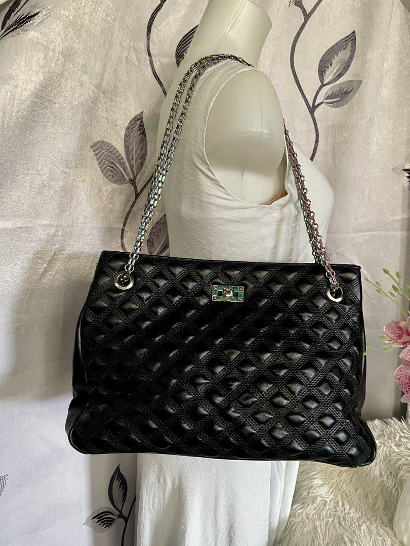 PRHA Black Quilted Shoulder Bag Rainbow Chain (Category: Shoulder Bags) located in Cabanatuan. Submitted by moraiahraven (Listing ID 1467257478, Image 1). Description: Stylish black quilted handbag with classic diamond-stitched pattern. Features dual metallic chain straps with a pretty iridescent/rainbow sheen, silver-tone hardware, and a front turn-lock clasp. Details: • Exterior: Soft black quilted material with diamond pattern • Straps: Double