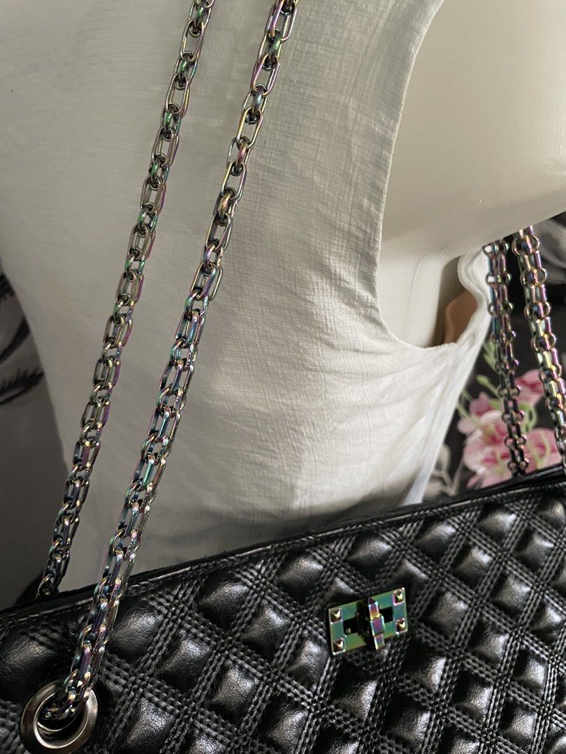 PRHA Black Quilted Shoulder Bag Rainbow Chain (Category: Shoulder Bags) located in Cabanatuan. Submitted by moraiahraven (Listing ID 1467257478, Image 2). Description: Stylish black quilted handbag with classic diamond-stitched pattern. Features dual metallic chain straps with a pretty iridescent/rainbow sheen, silver-tone hardware, and a front turn-lock clasp. Details: • Exterior: Soft black quilted material with diamond pattern • Straps: Double