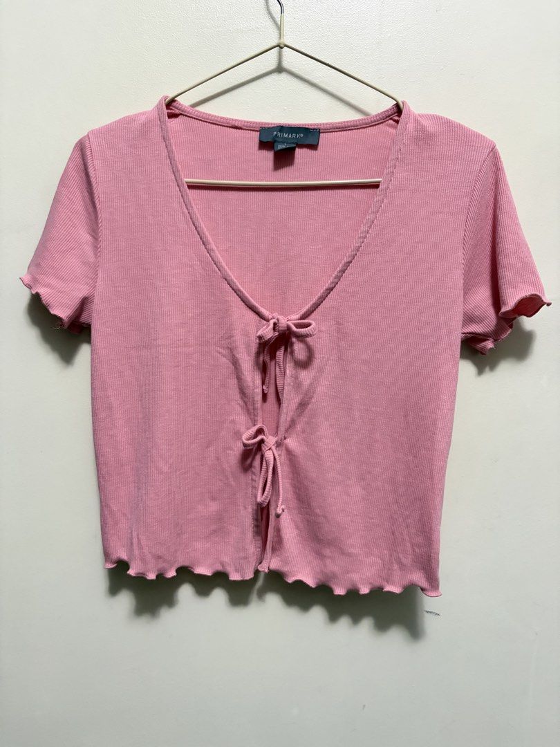 Primark Pink Ribbed Tie-Front Crop Top Size S (Category: Sleeveless) located in Quezon City. Submitted by j.steffy (Listing ID 1467327500, Image 1). Description: - Brand: Primark - Color: Pink - Style: Ribbed short sleeve top with deep V-neckline and double front tie closures - Details: Trendy lettuce hem on sleeves and bottom edge - Fabric: Soft and stretchy for all-day comfort - Condition: Brand new / Excellent - Perfect for: Casual everyday we