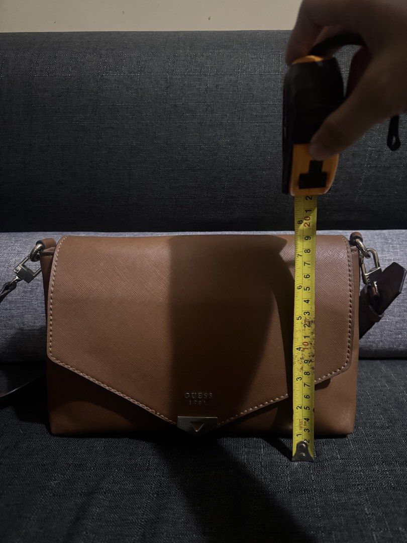 Guess envelope brown faux-leather (Category: Shoulder Bags) located in San Jose. Submitted by lalisamanofoot50726 (Listing ID 1467351884, Image 3). Description: BER MONTHS SALE Steal price all items‼️ Authentic Pre-love brown faux-leather Guess envelope-style shoulder or crossbody bag featuring a gold-tone triangle logo plate on the front flap..
