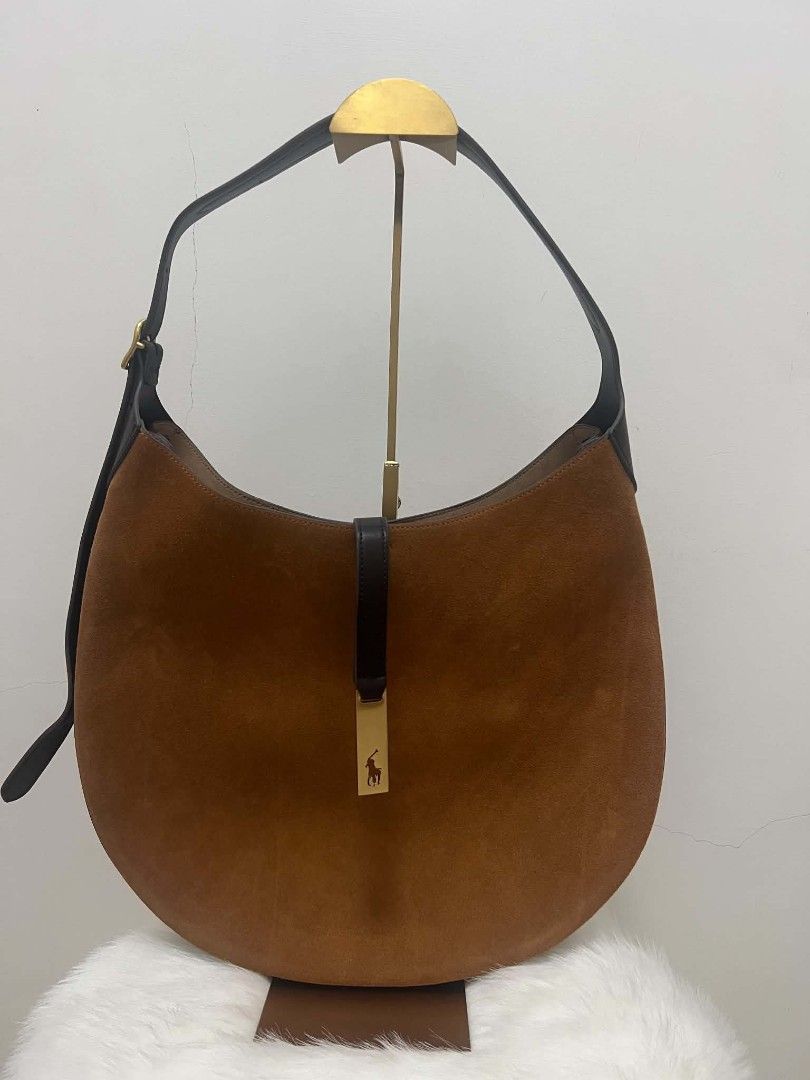 Ralph Lauren Polo Suede Shoulder Bag (Category: Shoulder Bags) located in Paoay. Submitted by rvf1230 (Listing ID 1467317951, Image 3). Description: - Brand: Polo Ralph Lauren - Material: Rich brown suede with dark leather trim - Strap: Adjustable dark leather strap - Closure & Details: Front flap strap with gold-toned logo plaque - Interior: Roomy with one zippered pocket and slip pockets - Inclusion: Original dust bag included - Condition: Exce