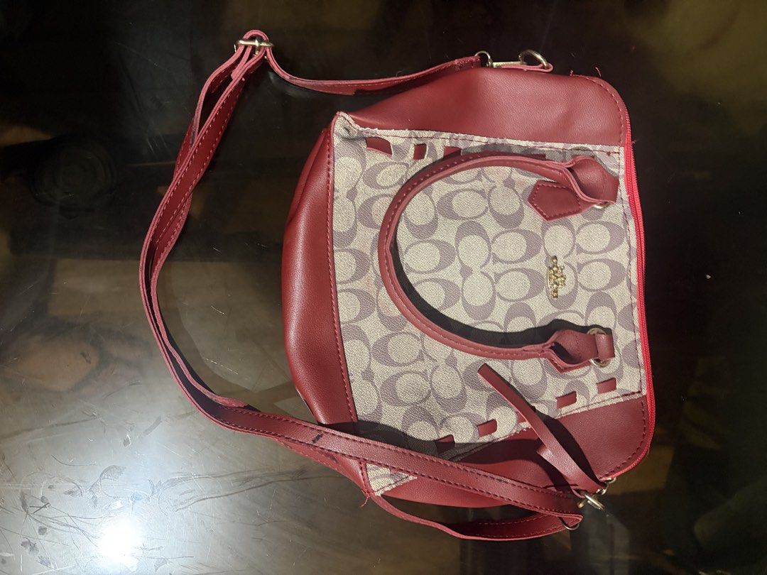 Red and Beige Monogram Crossbody Handbag (Category: Cross-body Bags) located in Manila. Submitted by mcllts (Listing ID 1467349111, Image 1). Description: - Design: Red and beige monogram pattern with striking red faux leather trim - Carry options: Sturdy top handles and a convenient adjustable shoulder strap - Closure: Secure top zipper closure - Condition note: Interior black lining shows significant wear, peeling, and marks (priced to clear) -