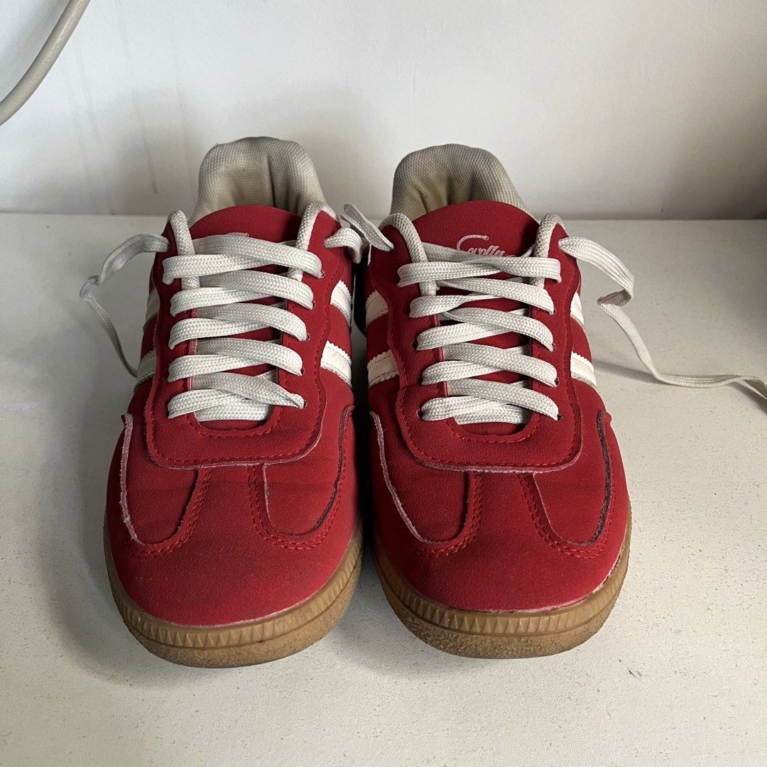 Red Corolla Shoes (Category: Sneakers) located in Caloocan City. Submitted by iamqwertyy (Listing ID 1467176218, Image 1). Description: - Size: 37 - Color/Design: Red suede with white stripes, white heel tab, and red script logo - Soles: Classic gum rubber - Condition: Uppers are in solid shape; shows light wear on the inner lining and laces - Style: Comfortable low-profile skate or casual walking sneakers.