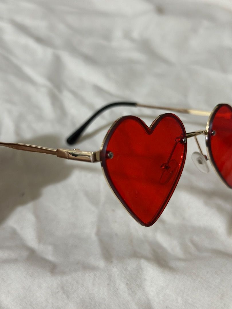 Red heart-shaped sunglasses with gold frame (Category: Babies & Kids Fashion) located in Mandaluyong City. Submitted by lovedbyjaaaam (Listing ID 1467284201, Image 2). Description: - Trendy red heart-shaped lenses with a stylish gold-tone wire frame - Comfortable black temple tips for all-day wear - Lightweight design with a clear red tint - Pristine condition: zero scratches on the lenses - Fun accessory for parties, festivals, or casual outdoor