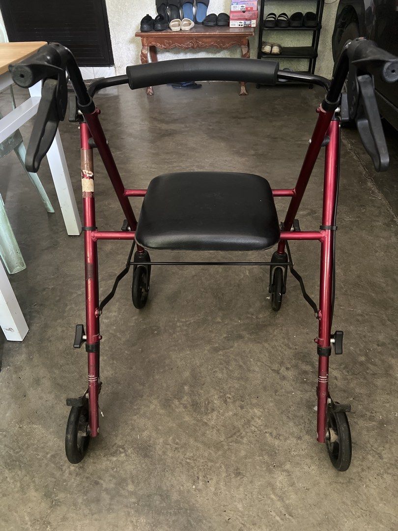 Red Rollator Walker with Seat and Wheels (Category: Wheelchairs) located in Bulacan. Submitted by Domozz (Listing ID 1467189334, Image 2). Description: - Type: 4-wheel rollator walker (mobility aid) - Color: Red frame with black padded seat and backrest - Features: Handbrakes, adjustable height handles, and smooth-rolling wheels - Condition: Sturdy and fully functional with minor cosmetic scuffs from normal use - Ideal for: Elderly or recovering 