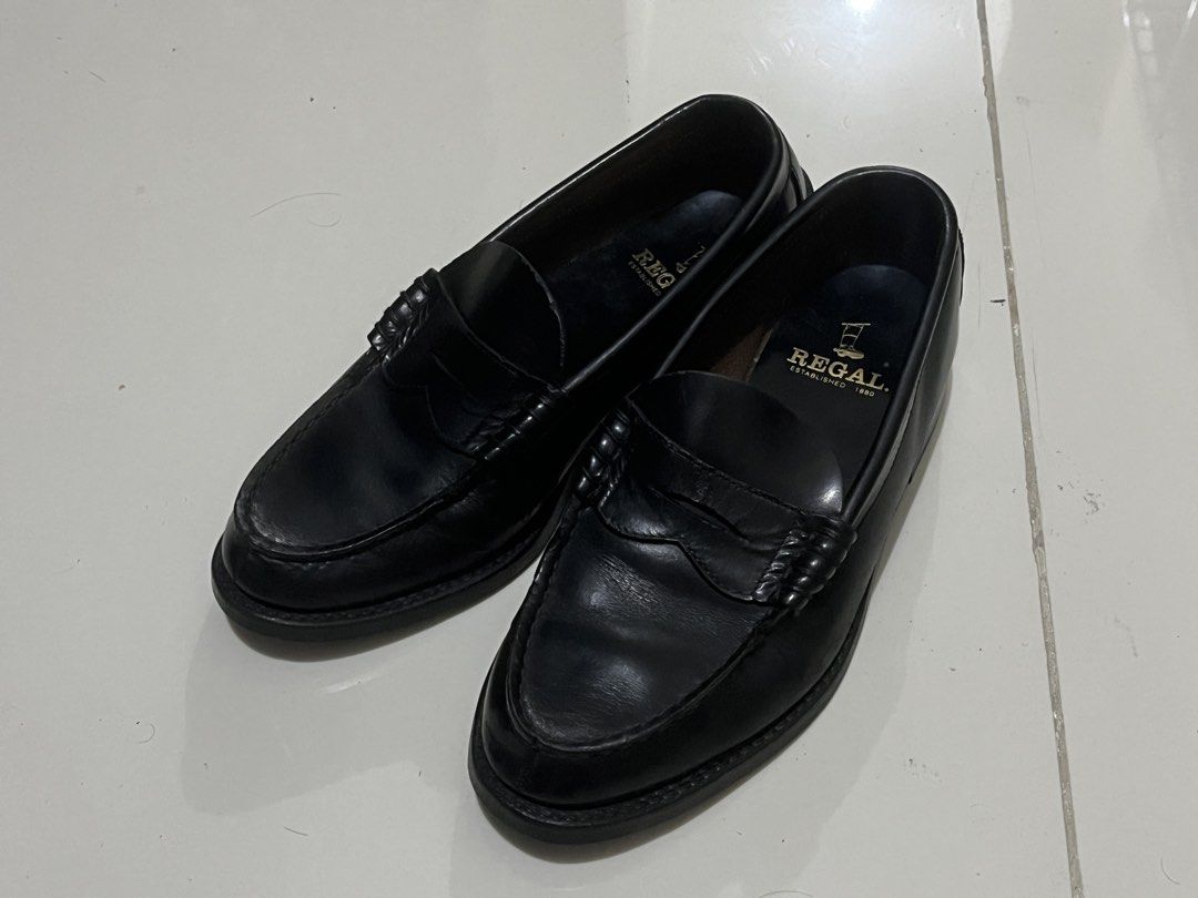 Regal Penny Loafers (Category: Loafers) located in Liliw. Submitted by sainttt_ (Listing ID 1467357723, Image 2). Description: - Brand: Regal Established 1880 - Style: Classic black leather penny loafers - Design: Slip-on with standard moc toe stitching and low block heels - Details: Gold stamped brand logo on insoles - Condition: Leather uppers show minor creasing from normal wear; solid rubber outsoles and heels - Perfect for smart-casual or fo
