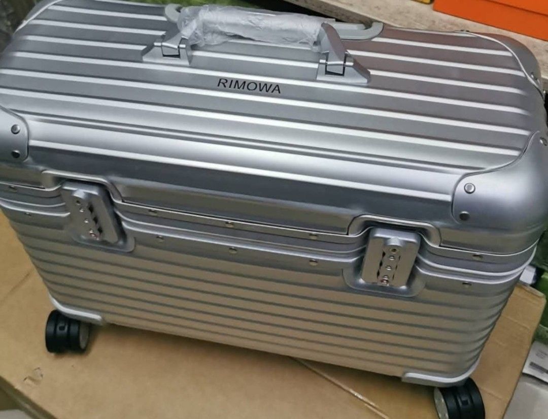 Ri Silver Aluminum Pilot 16 luggage (Category: Luggage) located in Manila. Submitted by dh3nz1 (Listing ID 1467212822, Image 2). Description: a silver aluminum hardshell pilot luggage - Iconic horizontal groove design with dual front combination locks - Top carry handle still wrapped in original protective plastic - Dark patterned fabric interior featuring a removable divider compartment - Includes a zippered pouch and multiple storage pockets in