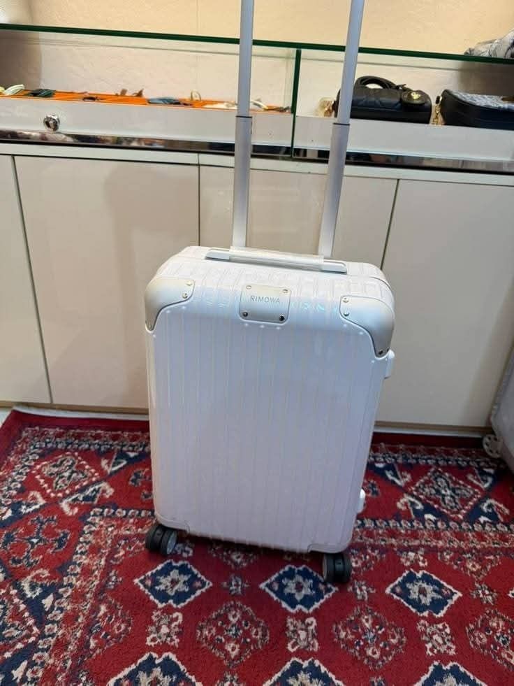 R-MOWA-- suitcase hard shell trolley with wheels and handle (Category: Luggage) located in Manila. Submitted by dh3nz1 (Listing ID 1467175596, Image 2). Description: - Color: Clean black finish - Design: Iconic vertical ribbed hard shell with front branded badge - Mobility: Smooth-gliding 4-spinner wheels - Handle: Fully functional telescopic pull handle - Protection: Durable metal corner guards - Size: Ideal for weekend trips and cabin baggage.