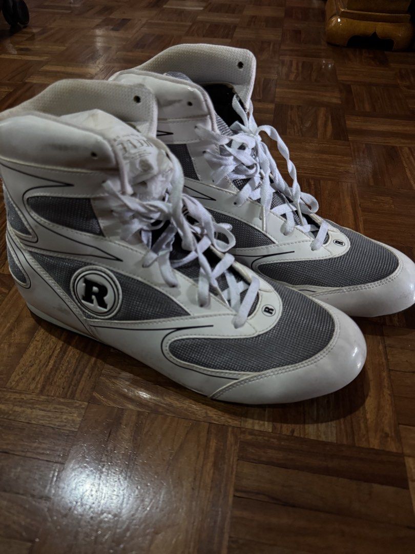 Ring Side Boxing Shoes White Grey US 11 (Category: Sneakers) located in Manila. Submitted by seangoart (Listing ID 1467174974, Image 2). Description: - Brand/Model: Ring Side Boxing Shoes - Color: White and Grey - Size: US 11 / EUR 45 1/3 - Design: High-top with lace-up closure and breathable mesh panels - Outsole: Durable rubber for canvas traction - Condition: Minor scuffs and marks on upper and soles from previous gym use - Perfect for trainin