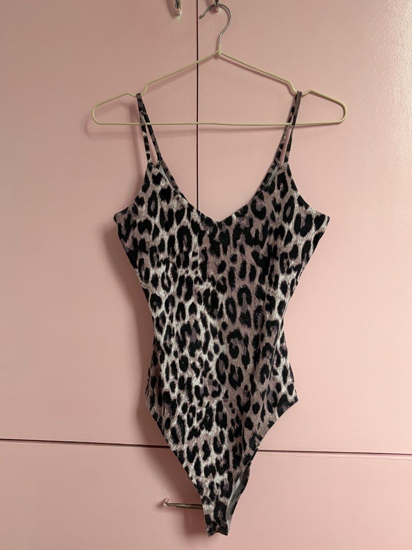 River Island Leopard print Bodysuit (Category: Sleeveless) located in Caloocan City. Submitted by fierceearth-2d5b (Listing ID 1467241281, Image 1). Description: - Brand: River Island - Style: Purple and black leopard print bodysuit - Size: UK 8 / US 4 - Details: Double spaghetti straps, V-neckline, snap button closure at the bottom - Fabric: Soft and stretchy for a comfortable fit - Styling: Perfect to pair with high-waisted jeans or skirts.