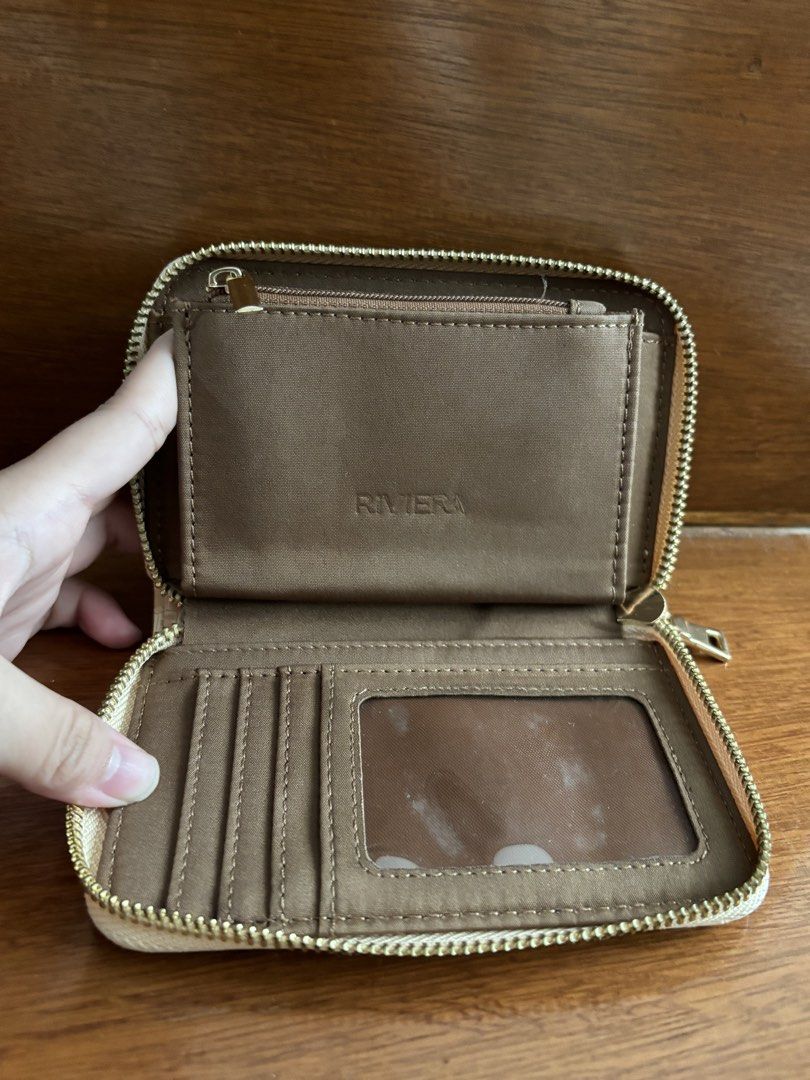Riviera Cream Crocodile Pattern Zip Around Wallet (Category: Wallets & Card holders) located in Manila. Submitted by gabuys (Listing ID 1467230507, Image 3). Description: - Brand: Riviera - Color: Cream with a stylish crocodile texture - Closure: Secure gold-tone all-around zip - Interior: Classic brown fabric lining - Storage: Multiple card slots, clear ID window, and a zippered coin pocket - Condition: Brand new / Excellent quality - Mode of Pa