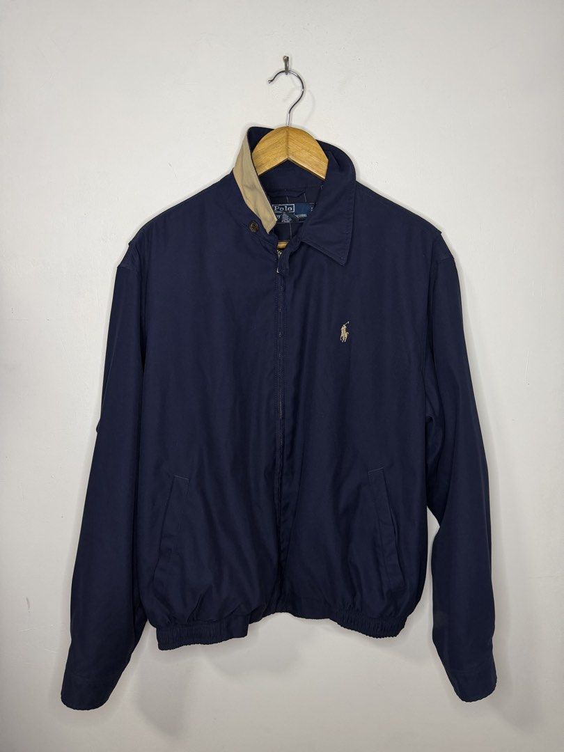 RL Bi-Swing Harrington Jacket (Blue) (Category: Coats, Jackets and Outerwear) located in Manila. Submitted by jcarchives14 (Listing ID 1467264787, Image 1). Description: - Brand: Polo Ralph Lauren - Color: Classic navy blue with contrast tan collar - Logo: Iconic embroidered pony logo in beige on the left chest - Closure: Full metal front zipper with dual button collar closure - Details: Ribbed cuffs and hem for a snug fit - Pockets: Two practica