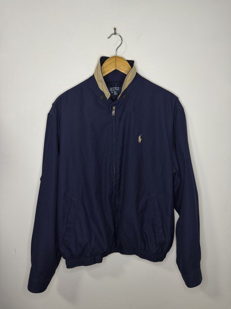 RL Bi-Swing Harrington Jacket (Blue) (Category: Coats, Jackets and Outerwear) located in Manila. Submitted by jcarchives14 (Listing ID 1467264787, Image 3). Description: - Brand: Polo Ralph Lauren - Color: Classic navy blue with contrast tan collar - Logo: Iconic embroidered pony logo in beige on the left chest - Closure: Full metal front zipper with dual button collar closure - Details: Ribbed cuffs and hem for a snug fit - Pockets: Two practica