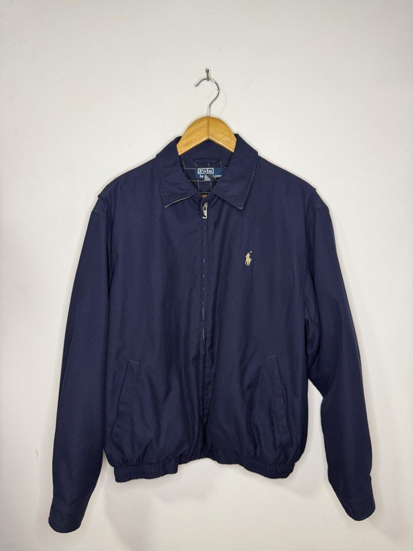 RL Bi-Swing Harrington Jacket (Blue) (Category: Coats, Jackets and Outerwear) located in Manila. Submitted by jcarchives14 (Listing ID 1467264787, Image 2). Description: - Brand: Polo Ralph Lauren - Color: Classic navy blue with contrast tan collar - Logo: Iconic embroidered pony logo in beige on the left chest - Closure: Full metal front zipper with dual button collar closure - Details: Ribbed cuffs and hem for a snug fit - Pockets: Two practica