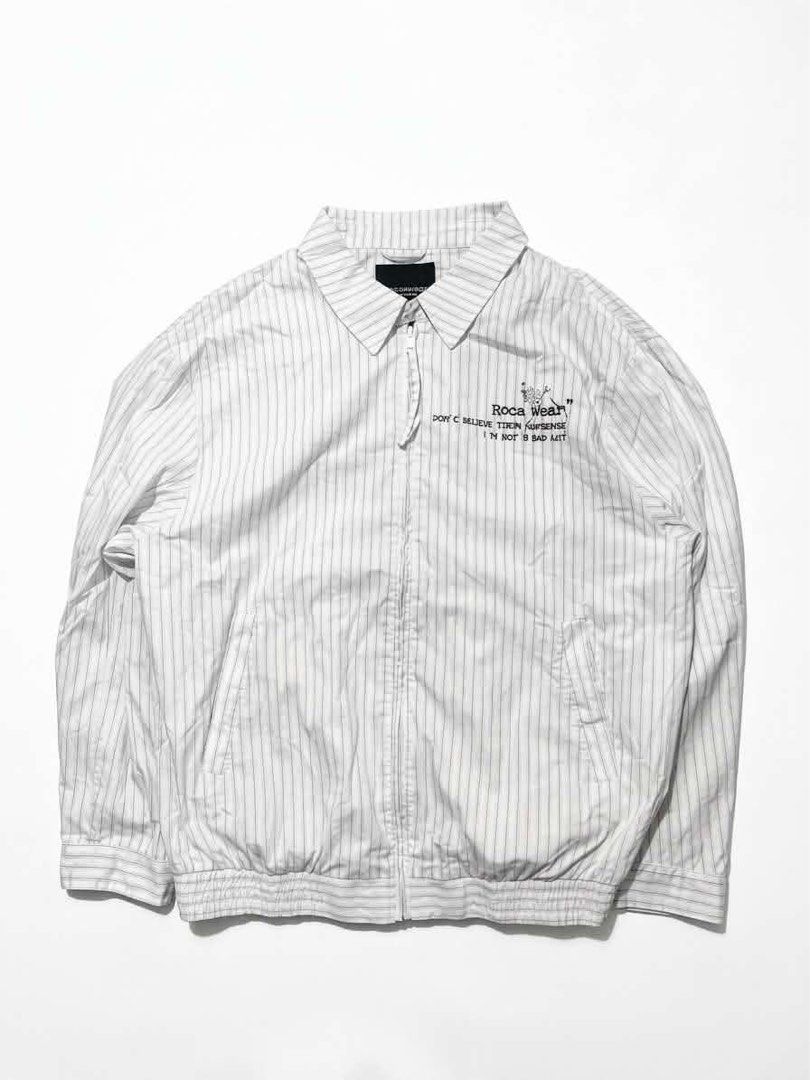 Rocawear White Blue Pinstripe Harington Jacket (Category: Coats, Jackets and Outerwear) located in Manila. Submitted by randomloots2 (Listing ID 1467291349, Image 1). Description: - Brand: Rocawear - Color: White with blue pinstripes - Style: Full zip jacket with collar neckline, elasticized hem and cuffs - Graphic: "Rocawear Don't believe their nonsense I'm not a bad guy" print on chest - Size: XXL (185/104A) - Condition: Great streetwear piece,