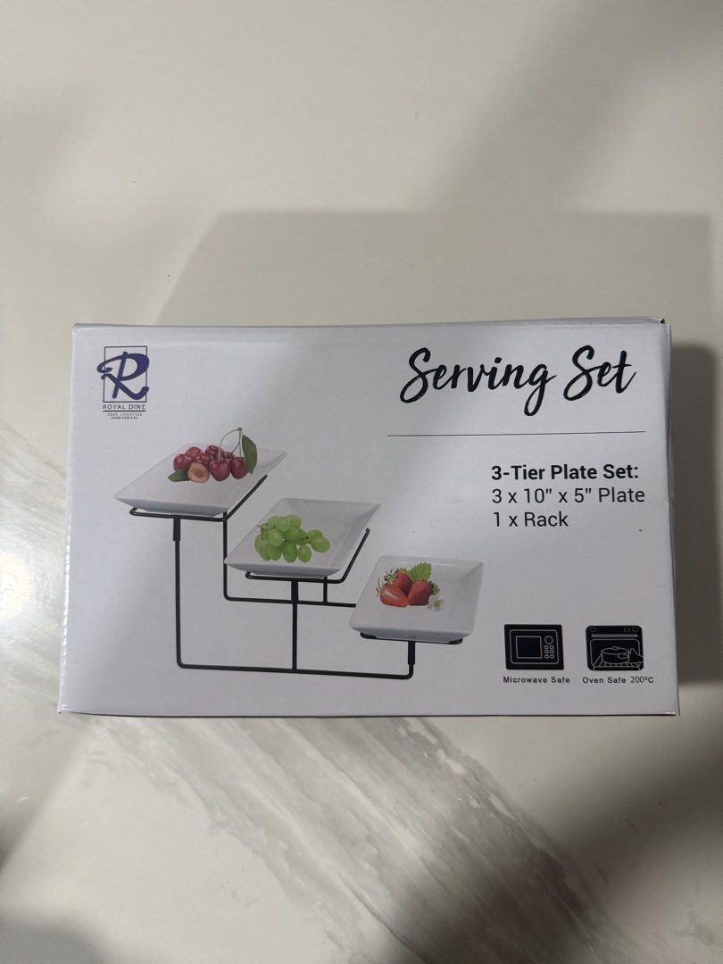 Royal Dine 3-Tier Plate Serving Set (Category: Dinnerware & Cutlery) located in Bacoor. Submitted by cielo1985 (Listing ID 1467276986, Image 1). Description: - Brand new in box Royal Dine serving set - Includes 3 rectangular plates (10x5 inches) and 1 black metal rack - Perfect for serving snacks, fruits, or desserts at parties - Microwave safe and oven safe up to 200°C - Easy to assemble, use, and store away.