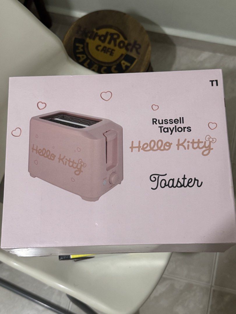 Bread Toaster (Category: Ovens & Toasters) located in Singapore. Submitted by anniegoh121212 (Listing ID 1467263191, Image 1). Description: - Official Sanrio Kitty licensed toaster by Russell Taylors - Cute pink design with original box packaging included - 750W power output for quick and even toasting - Adjustable browning knob and stop button for control - 30mm extra-wide slots with auto-centering guide - Safe and convenient with auto shut-off 