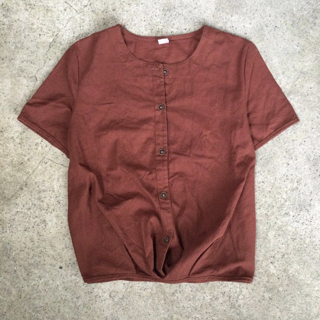 Rust / Terracotta Short-Sleeve Knotted Hem Blouse (Category: Blouses) located in Binangonan. Submitted by ininnep (Listing ID 1467327313, Image 1). Description: ✅ Brand XMET 👕 Item Rust / Terracotta Short-Sleeve Knotted Hem Blouse 📝 Details • Color: Warm rust / burnt orange / terracotta • Neckline: Round collarless neck (band collar style) • Closure: Button-front placket with 5 dark round buttons • Hem: Cute twisted/knot detail at front — creat