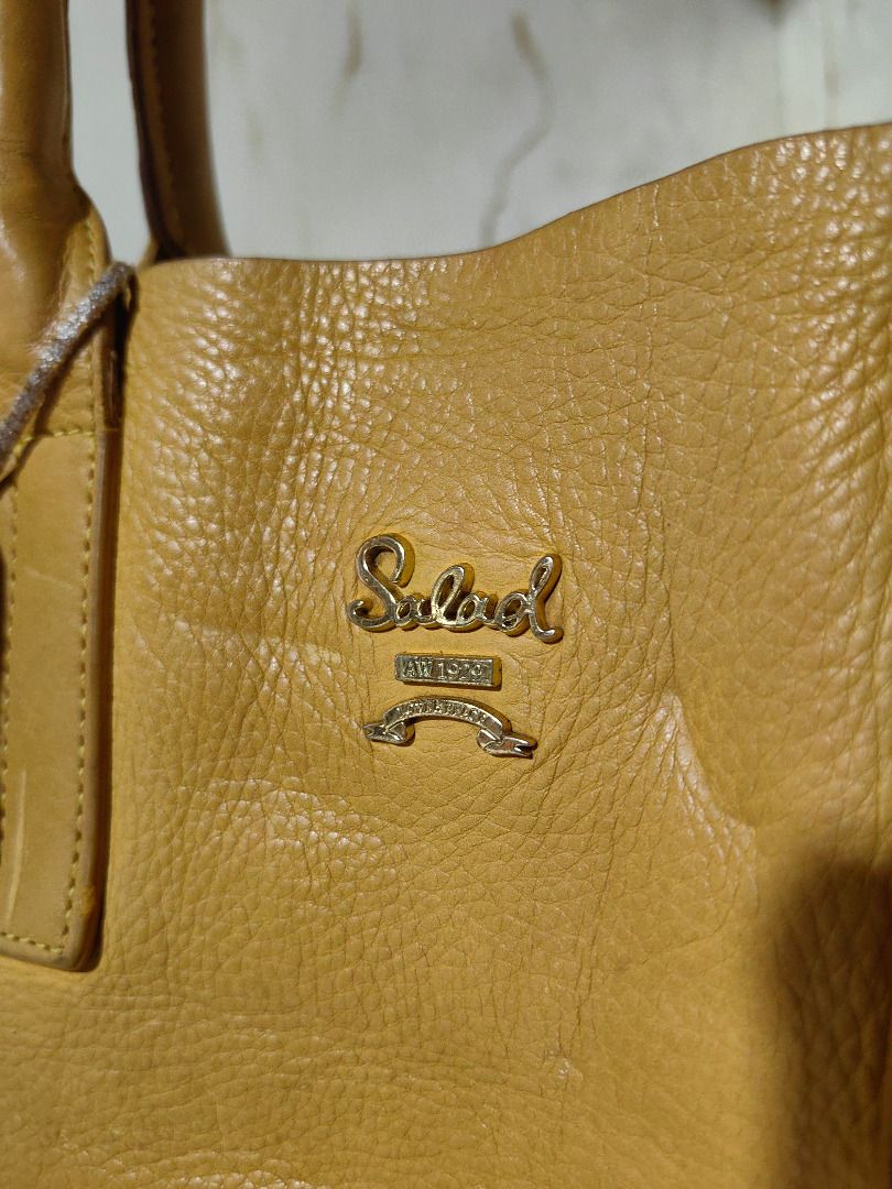 Salad Yellow Leather Tote Bag (Category: Tote Bags) located in Tarlac. Submitted by jeremiah.curator.2026 (Listing ID 1467195491, Image 2). Description: - Brand: Salad - Material: Genuine yellow pebbled leather - Closure: Zip closure with dual pullers - Handles: Double top handles - Hardware: Gold-tone - Extras: Matching leather brand tag included - Interior: Spacious and roomy for daily essentials.