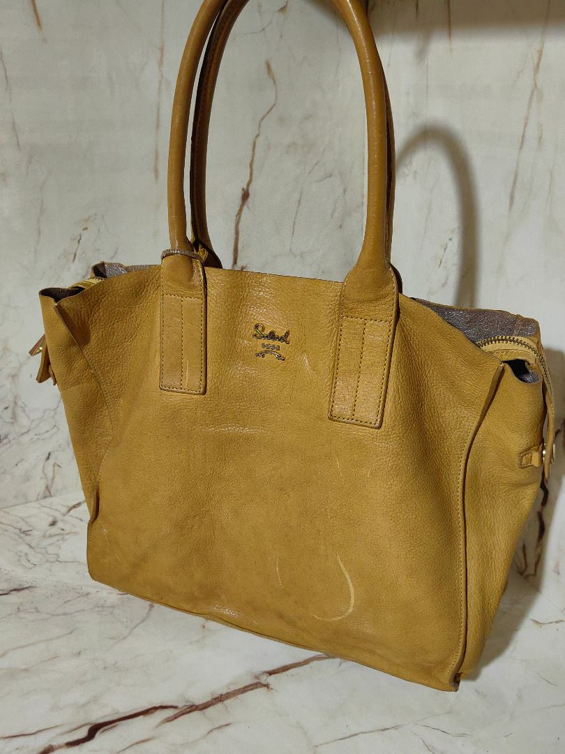 Salad Yellow Leather Tote Bag (Category: Tote Bags) located in Tarlac. Submitted by jeremiah.curator.2026 (Listing ID 1467195491, Image 1). Description: - Brand: Salad - Material: Genuine yellow pebbled leather - Closure: Zip closure with dual pullers - Handles: Double top handles - Hardware: Gold-tone - Extras: Matching leather brand tag included - Interior: Spacious and roomy for daily essentials.