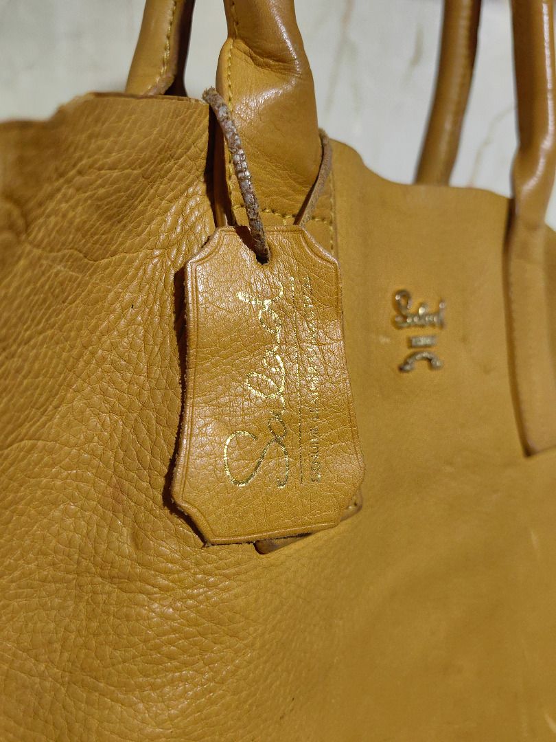Salad Yellow Leather Tote Bag (Category: Tote Bags) located in Tarlac. Submitted by jeremiah.curator.2026 (Listing ID 1467195491, Image 3). Description: - Brand: Salad - Material: Genuine yellow pebbled leather - Closure: Zip closure with dual pullers - Handles: Double top handles - Hardware: Gold-tone - Extras: Matching leather brand tag included - Interior: Spacious and roomy for daily essentials.