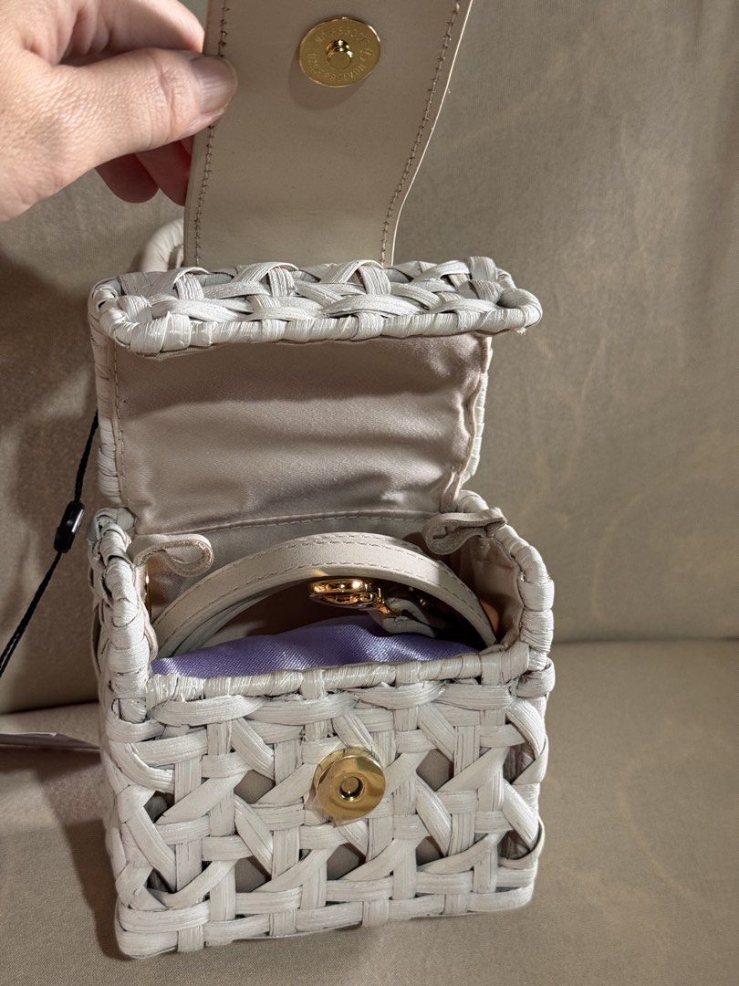 Samsung x Aranaz Mini Charlie Bag (Category: Cross-body Bags) located in Marikina City. Submitted by 1stuffshop (Listing ID 1467182817, Image 3). Description: - Brand: Samsung x Aranaz - Style: Mini Charlie Bag - Design: Handcrafted white woven with gold hardware and front metal plaque - Closure: Magnetic closure with top handle - Extras: Includes original tag and detachable strap.