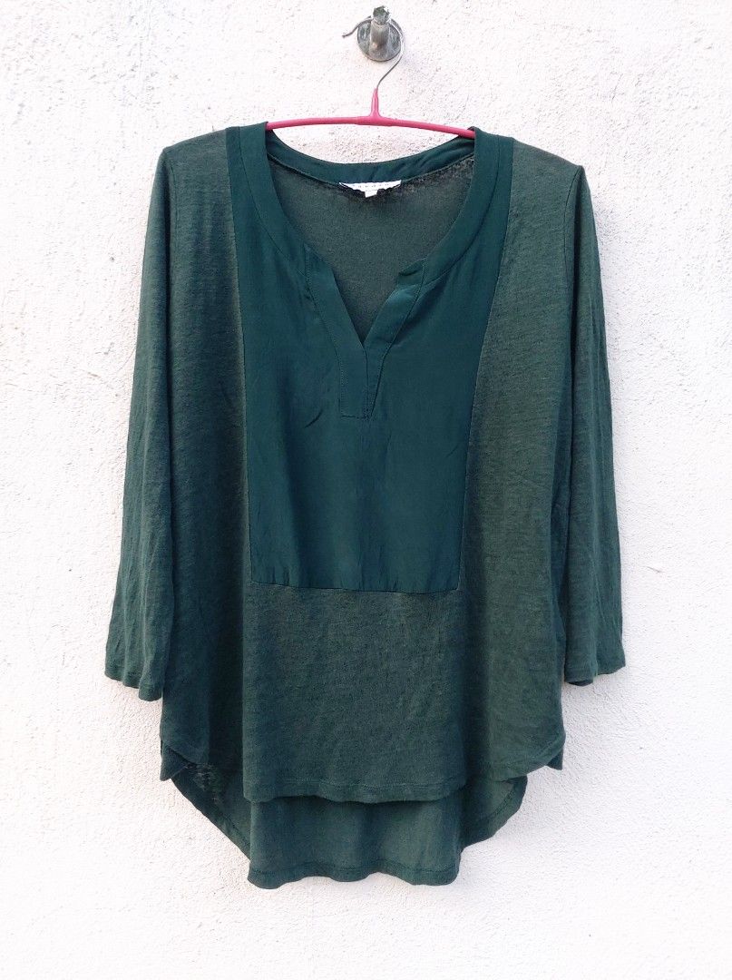 Sandro Dark Green Split Neck Blouse (Category: Blouses) located in Lapu Lapu. Submitted by agnesapm_29813 (Listing ID 1467295952, Image 1). Description: - Color: Dark green - Neckline: Split V-neckline with a contrast satin-feel front panel - Material: Lightweight textured knit body and sleeves - Fit: Relaxed and loose through the torso - Details: Curved high-low hem in the back - Style: Casual everyday top.
