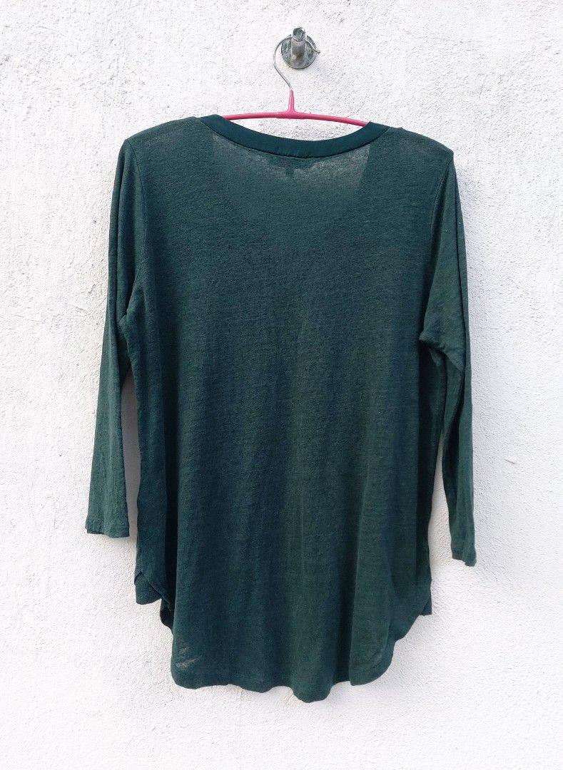 Sandro Dark Green Split Neck Blouse (Category: Blouses) located in Lapu Lapu. Submitted by agnesapm_29813 (Listing ID 1467295952, Image 3). Description: - Color: Dark green - Neckline: Split V-neckline with a contrast satin-feel front panel - Material: Lightweight textured knit body and sleeves - Fit: Relaxed and loose through the torso - Details: Curved high-low hem in the back - Style: Casual everyday top.