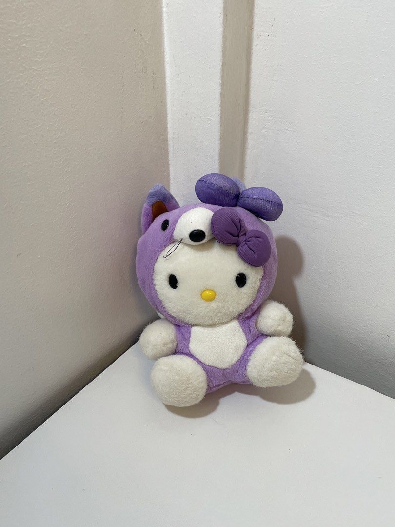 Sanrio Hello Kitty Lavender Fox Costume Plush (Category: Plushies & Soft Toys) located in Iba. Submitted by wealtheallymari99 (Listing ID 1467268544, Image 2). Description: - Character: Kitty in a cute purple fox costume - Details: Features a matching lavender bow and ' Kitty Lavender' tag on the back - Size/Pose: Roughly sitting position - Condition: Clean, soft, and in great shape - Ideal for: Sanrio fans and plushie collectors.