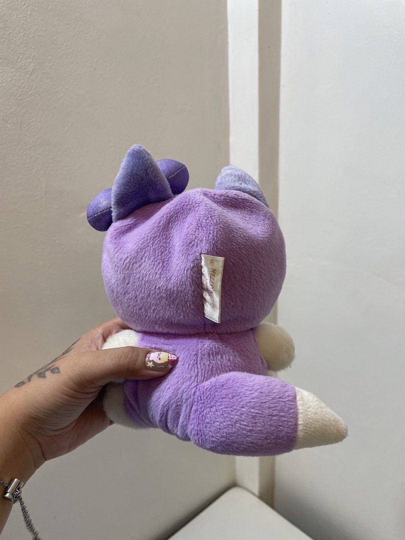 Sanrio Hello Kitty Lavender Fox Costume Plush (Category: Plushies & Soft Toys) located in Iba. Submitted by wealtheallymari99 (Listing ID 1467268544, Image 3). Description: - Character: Kitty in a cute purple fox costume - Details: Features a matching lavender bow and ' Kitty Lavender' tag on the back - Size/Pose: Roughly sitting position - Condition: Clean, soft, and in great shape - Ideal for: Sanrio fans and plushie collectors.