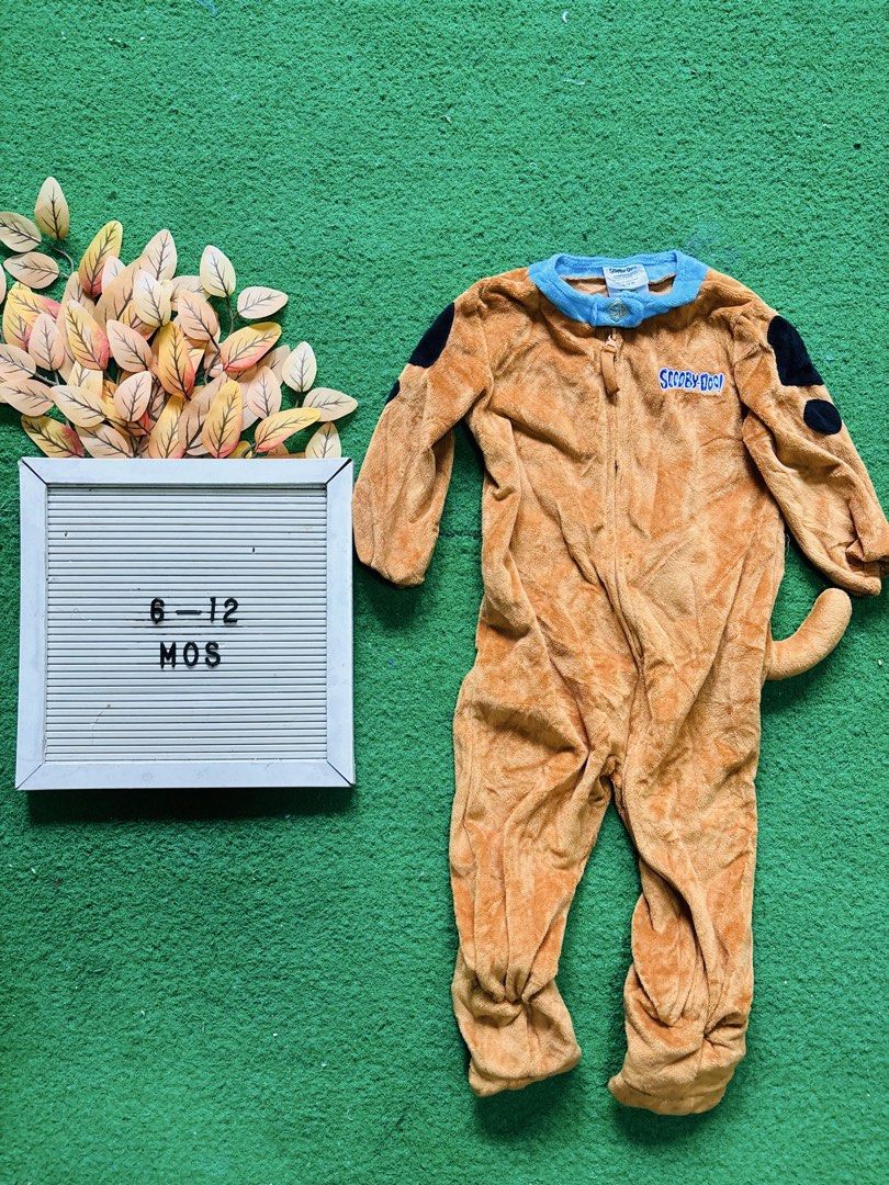 Scooby-Doo Baby Romper 6-12 Months (Category: Babies & Kids Fashion) located in San Mateo. Submitted by ariakid47 (Listing ID 1467343466, Image 1). Description: - Size: 6 to 12 months - Design: Super soft brown Scooby-Doo romper with blue collar and embroidered logo - Cute Details: Black spots on shoulders and an attached tail at the back - Practical Features: Covered feet to keep tiny toes warm and a convenient zip front closure for easy dressin